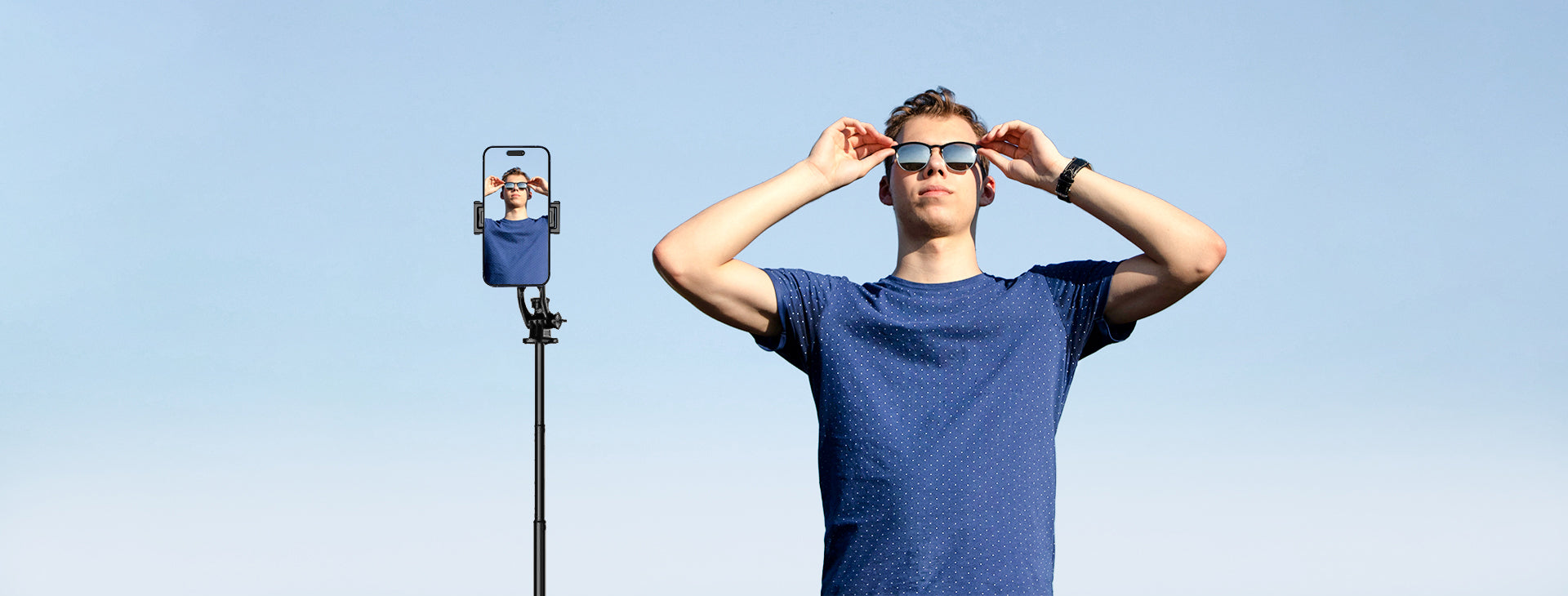 Man taking selfie with the selfie stick tripod