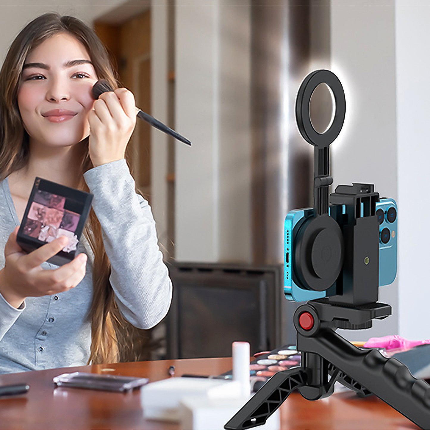 A woman uses her mobile phone's selfie light to apply makeup before going live.